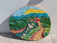 Load image into Gallery viewer, Round mosaic artwork depicting the Great Wall of China landscape, displayed in a garden