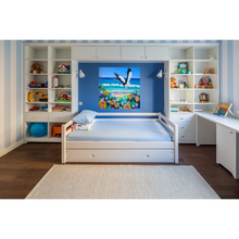 Load image into Gallery viewer, Colourful painting of a sea eagle flying over a beach with flowers and waves, displayed on a wall in a child's bedroom