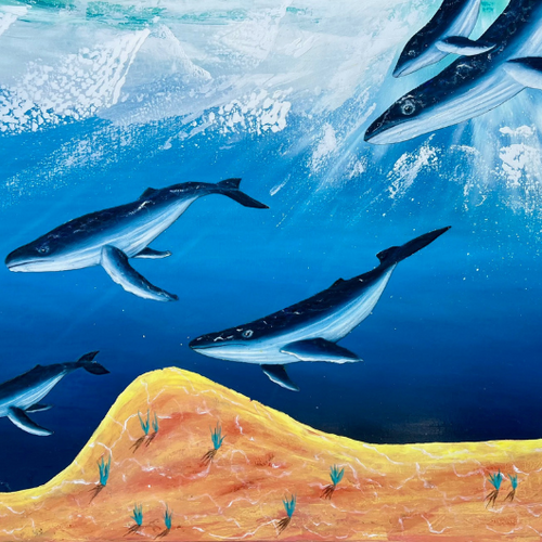 Whales swimming in a blue ocean with a mountainous underwater landscape.