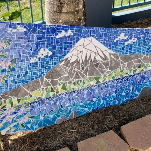 A custom mosaic artwork featuring a Mt Fuji landscape, perfect to place in your garden